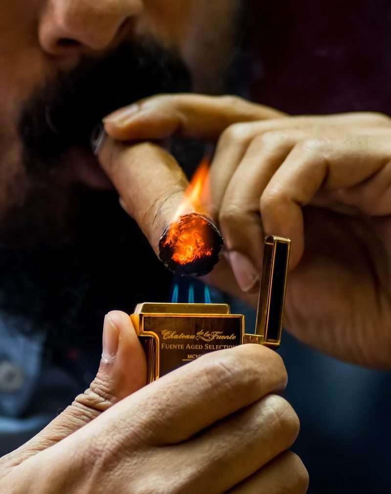 Lighting a cigar with a Chateau de la Fuente lighter